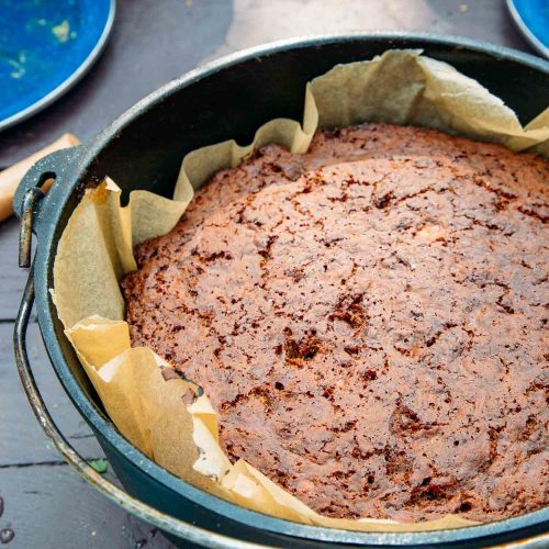 Side view of banana bread in a cast iron dutch oven.