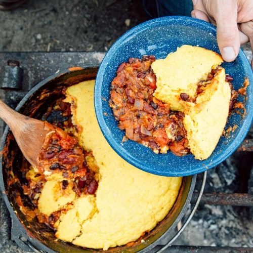 Serving vegetarian chili cooked in a Dutch oven on the campfire