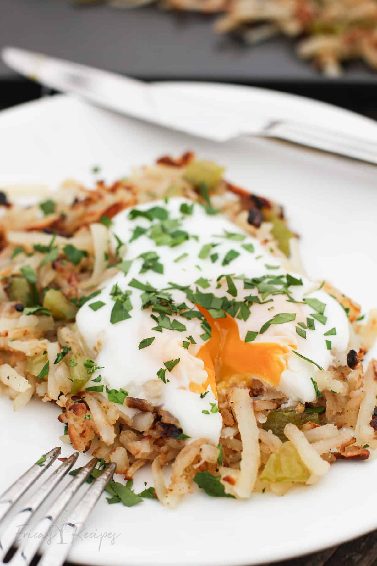 Hashbrowns with a runny yolk egg on top.
