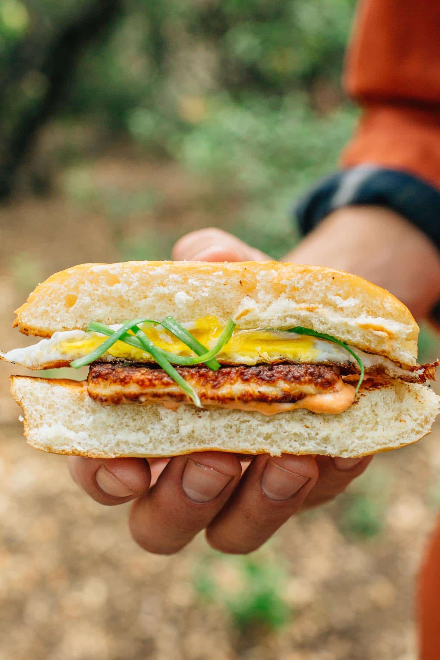 Holding a halloumi breakfast sandwich