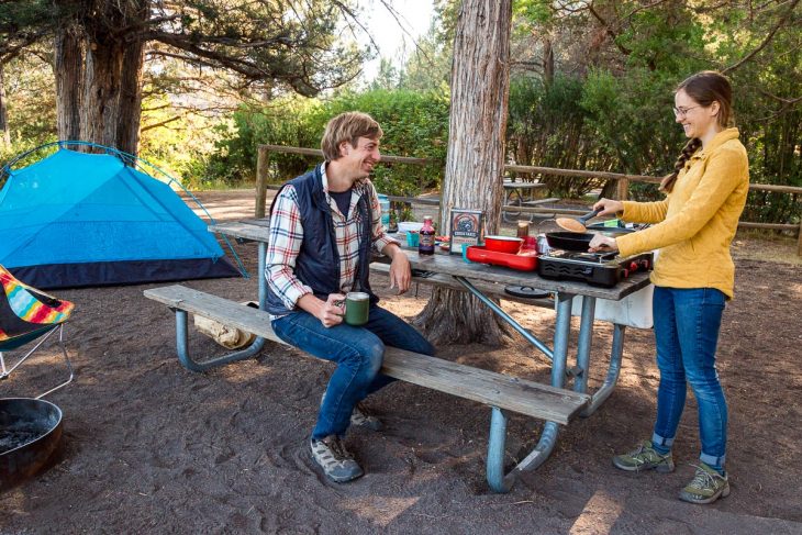 Michael and Megan cooking at a campsite