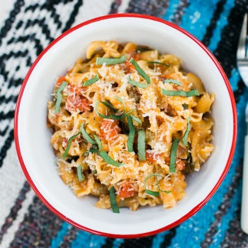 Pasta in a red and white bowl