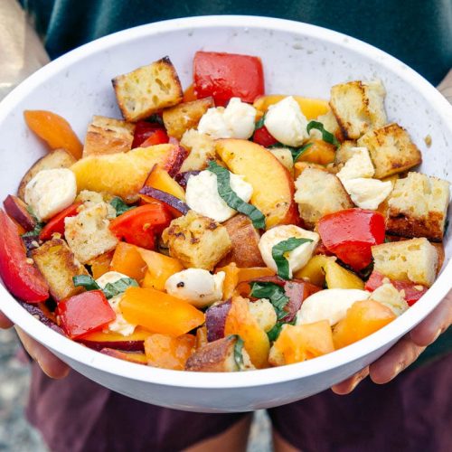 Megan holding a bowl of panzanella bread salad
