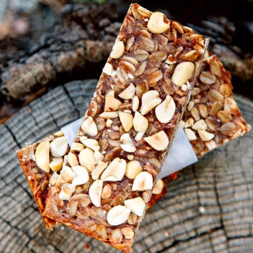 Two granola bars on a stump.