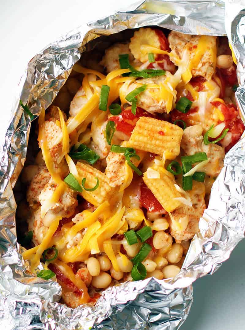 Chicken, vegetables, and cheese in a foil packet.