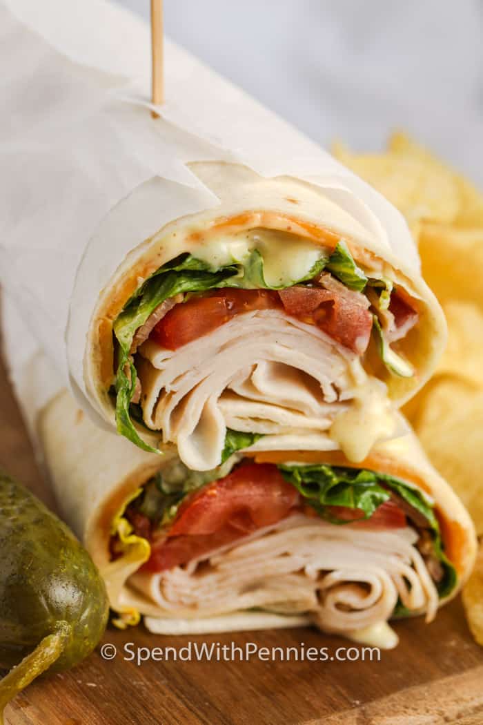 Turkey wraps with chips in the background.