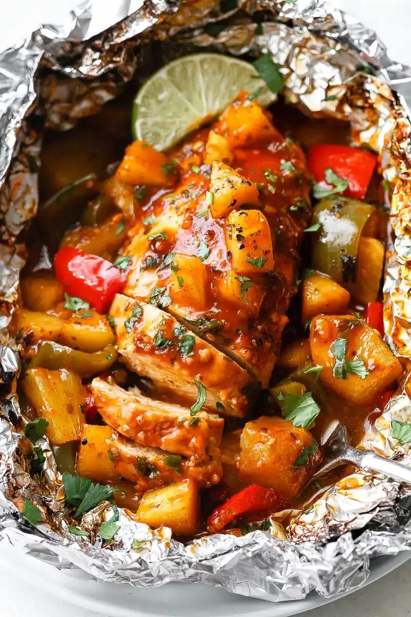 Sliced chicken breast and vegetables topped with BBQ sauce.