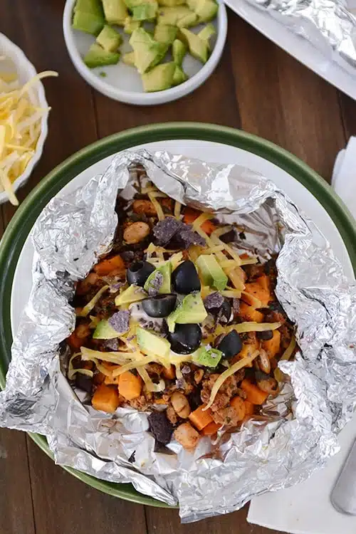 Cubes of sweet potatoes topped cheese and olives.