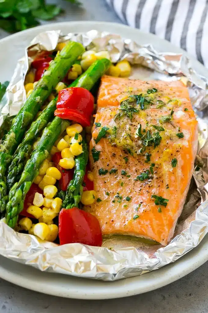 Salmon next to asparagus and corn.
